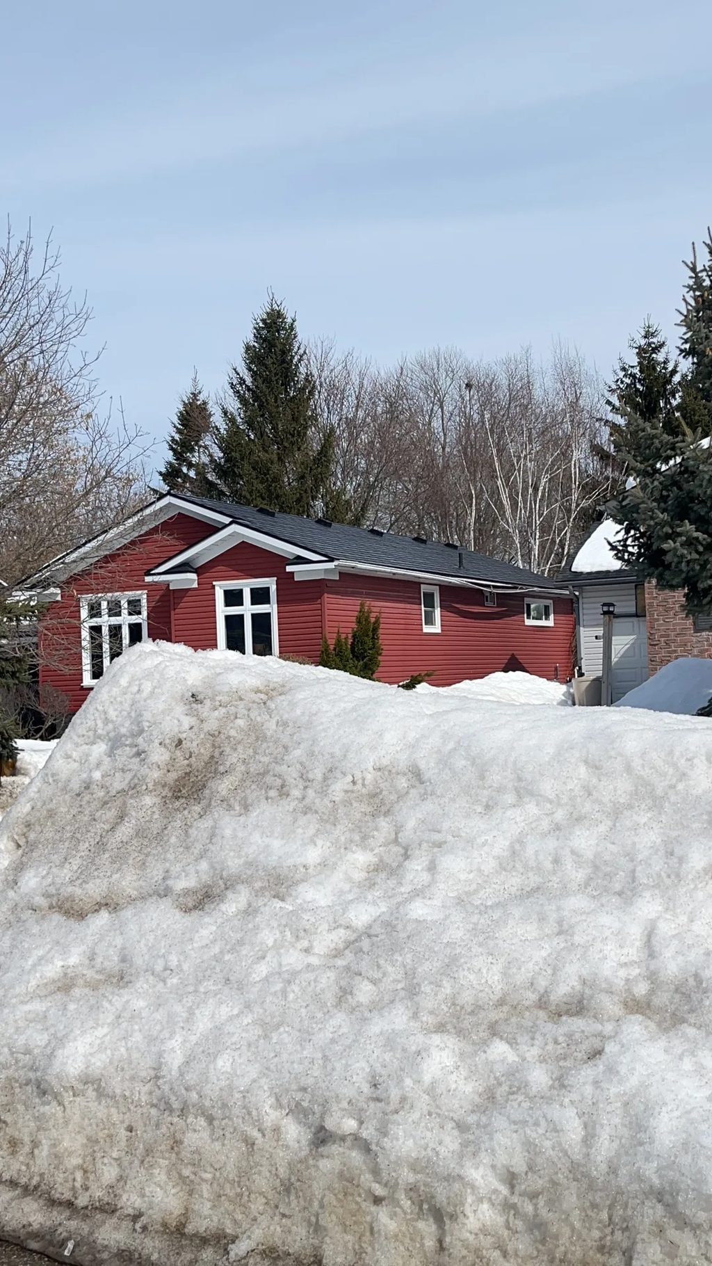 Black Interlock Slate aluminum roof on a red one-storey ranch home with a black metal roof in a, Orillia, Ontario
