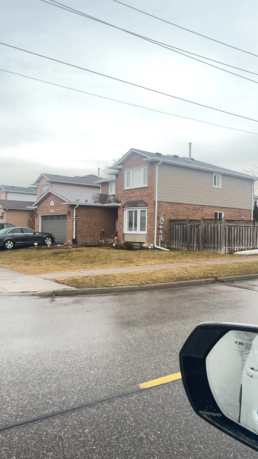 Tudor Brown Interlock Slate aluminum roof on a Tudor-style home with a metal roof in a suburban street, Burlington, Ontario