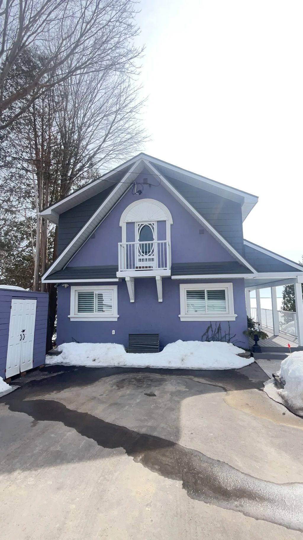 Musket Grey Interlock Cedar Shingle aluminum roof on a grey cottage with a grey metal roof among tall trees, Severn, Ontario