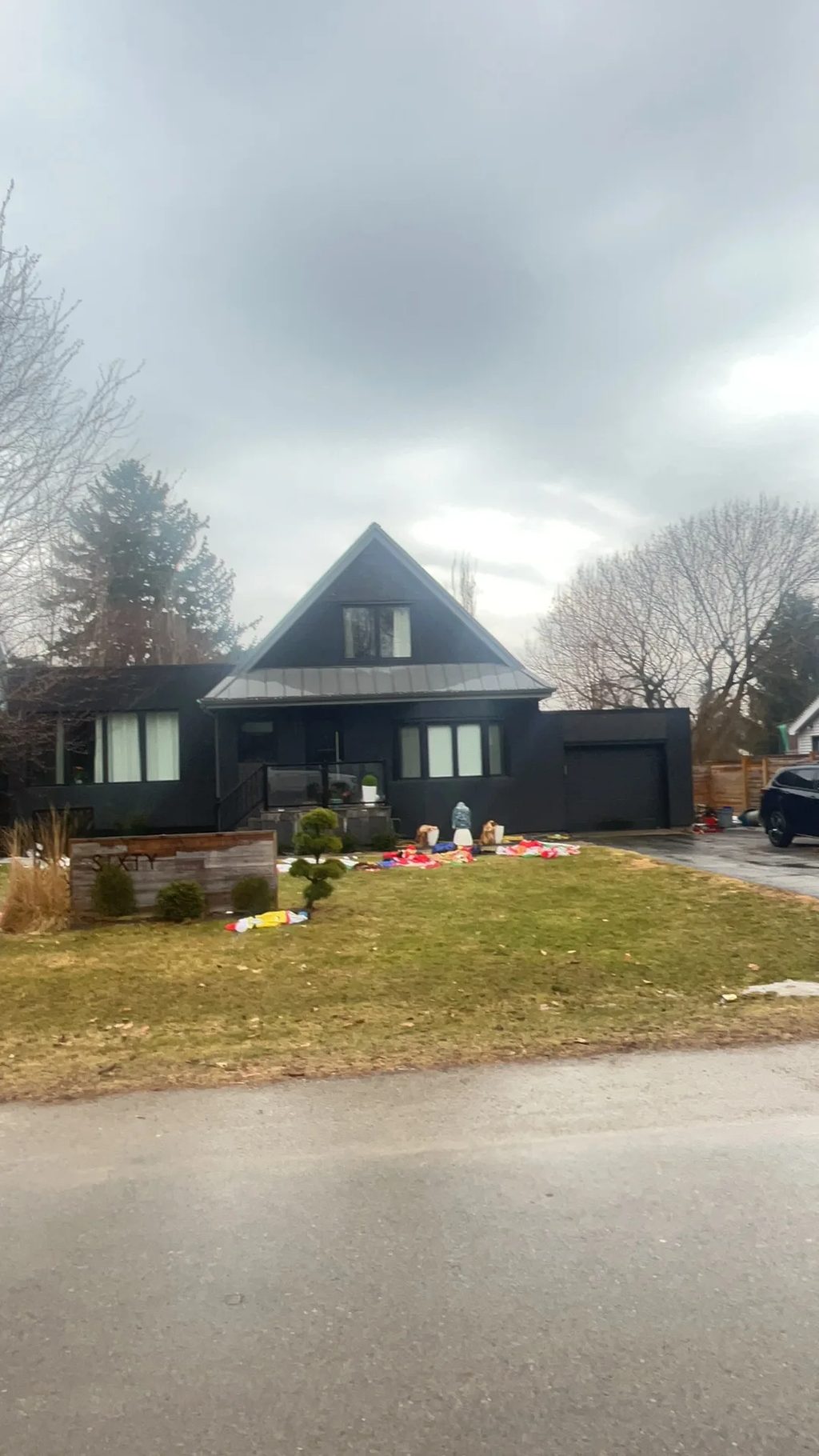 Musket Grey Interlock Standing Seam aluminum roof being installed on a dark grey, two-storey home with a metal roof under, Burlington, Ontario