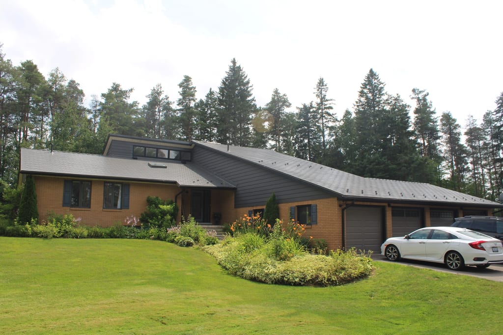 Musket Grey Interlock Cedar Shingle aluminum roof on a brown single-family home with a Musket Grey metal roof in, Mono, Ontario