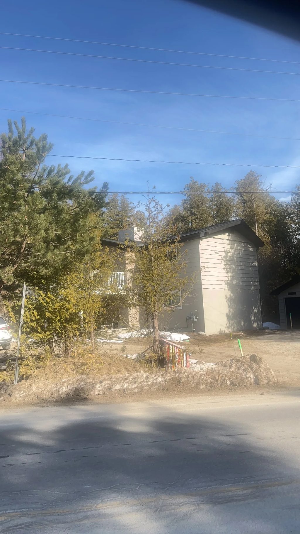 Black Interlock Slate aluminum roof being installed on a single-family home with a metal roof among trees in the, The Blue Mountain, Ontario