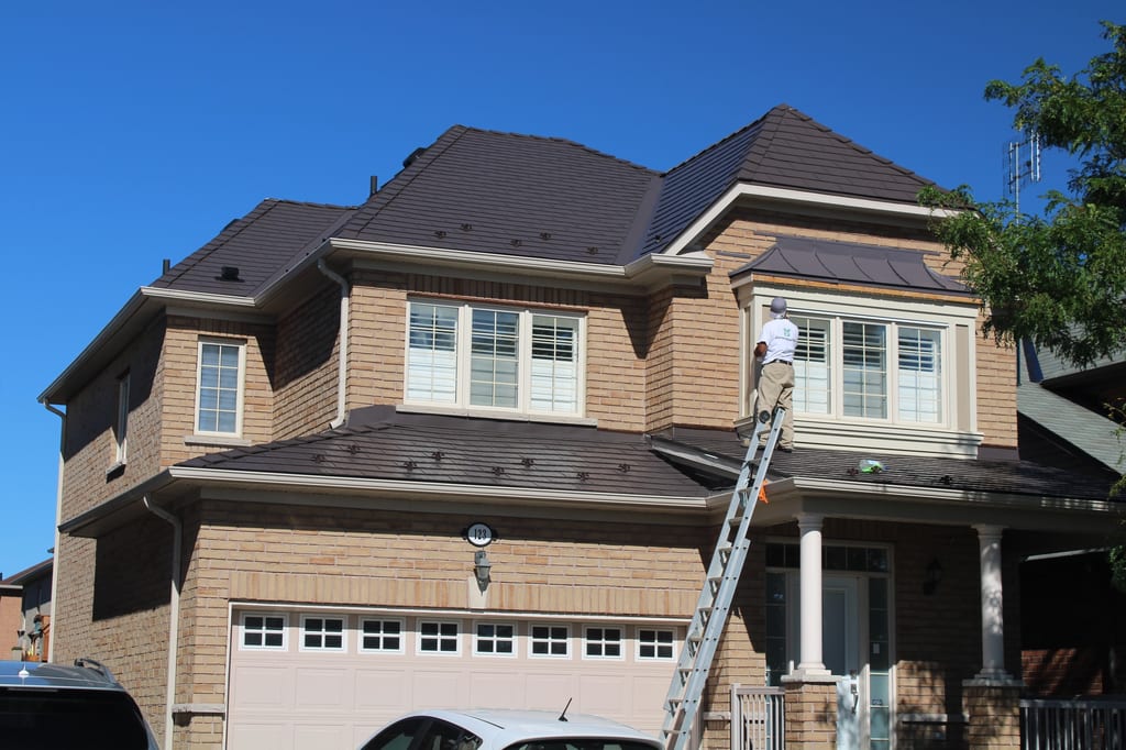 Tudor Brown Interlock Cedar Shingle aluminum roof on a Tudor Brown metal roof being installed on a two-storey, Brampton, Ontario
