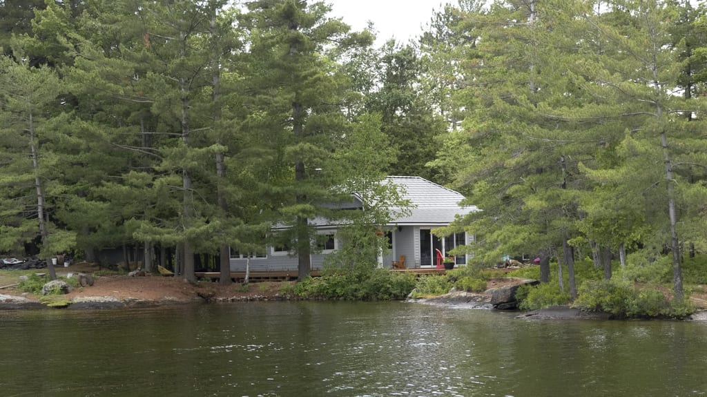 Deep Charcoal Interlock Cedar Shingle aluminum roof on a small house with a metal roof among trees on a lake, Winderemere, Ontario