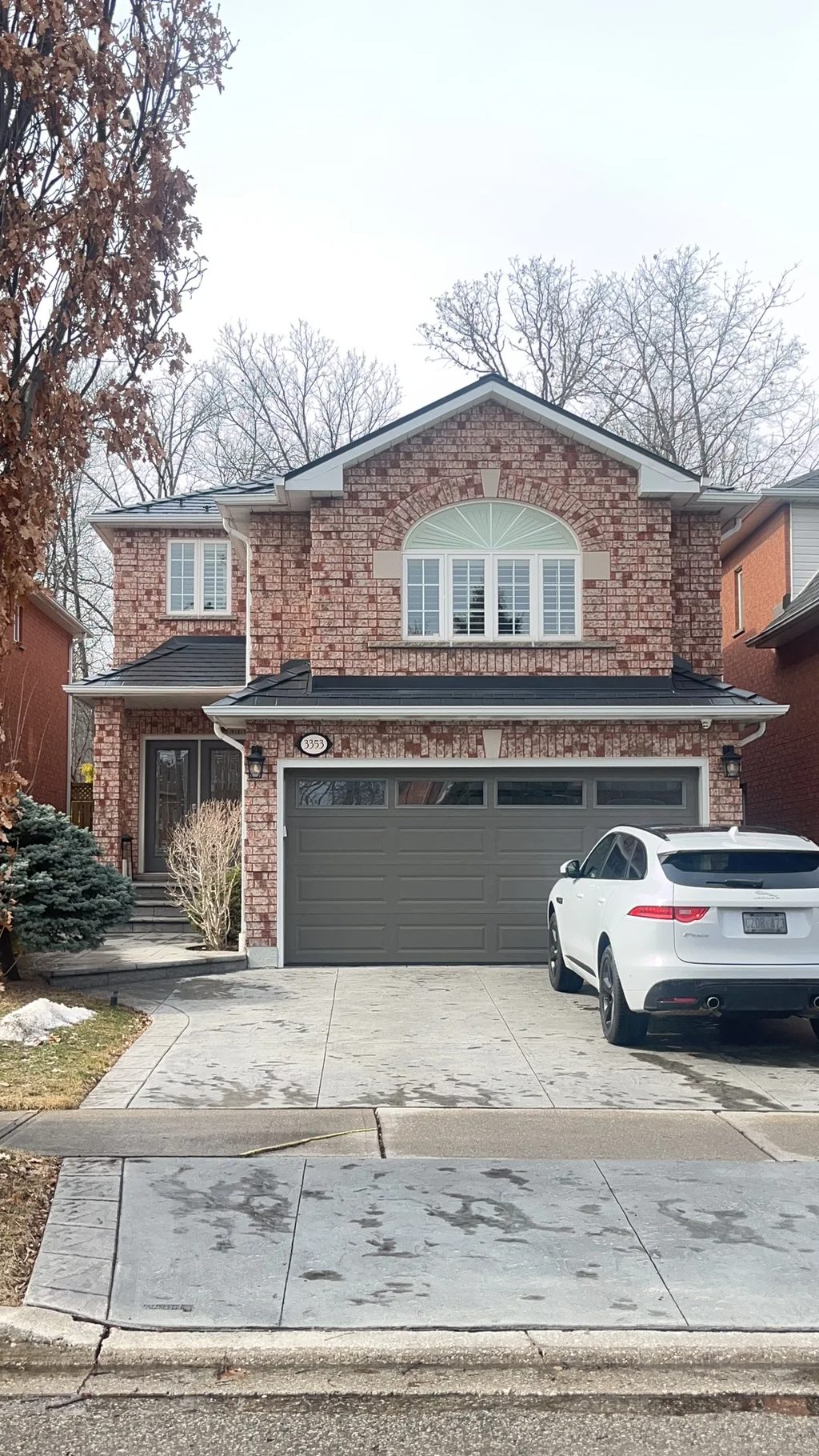 Black Interlock Slate aluminum roof on a two-storey home with a black metal roof in a forested, Mississauga, Ontario