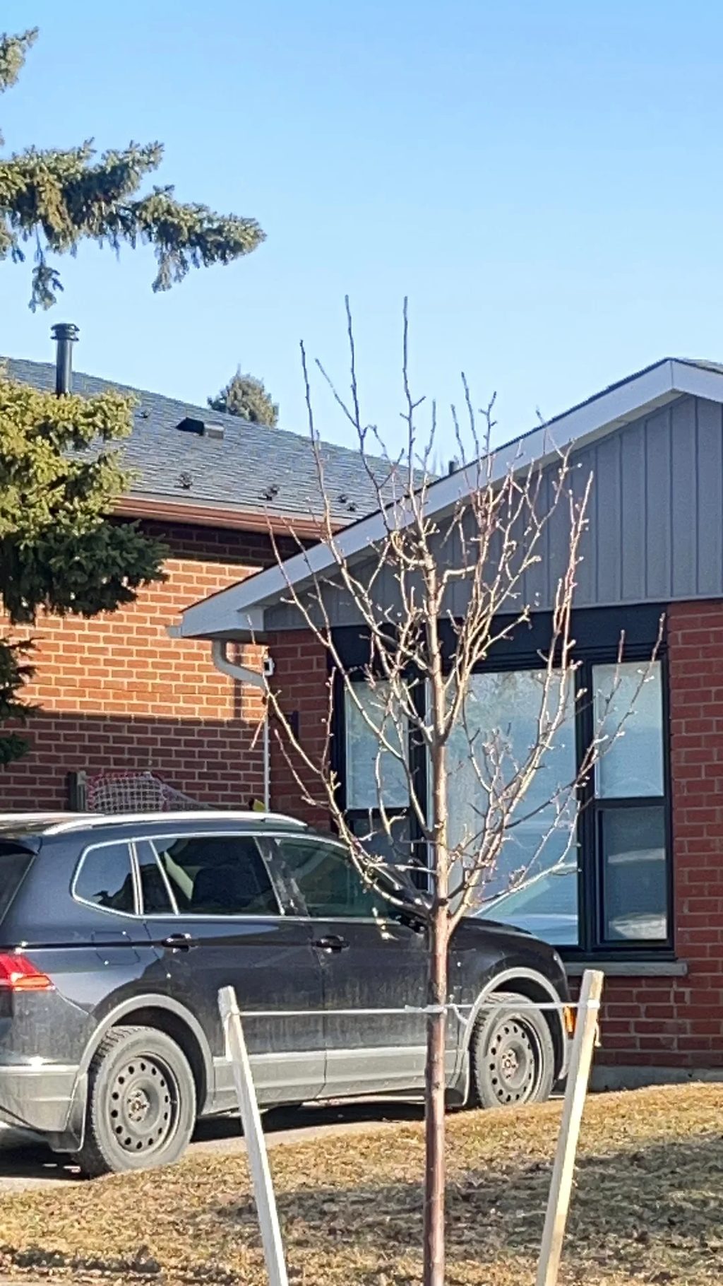 Black Interlock Slate aluminum roof on a black single-family modern home with dormers among tall, Orangeville, Ontario