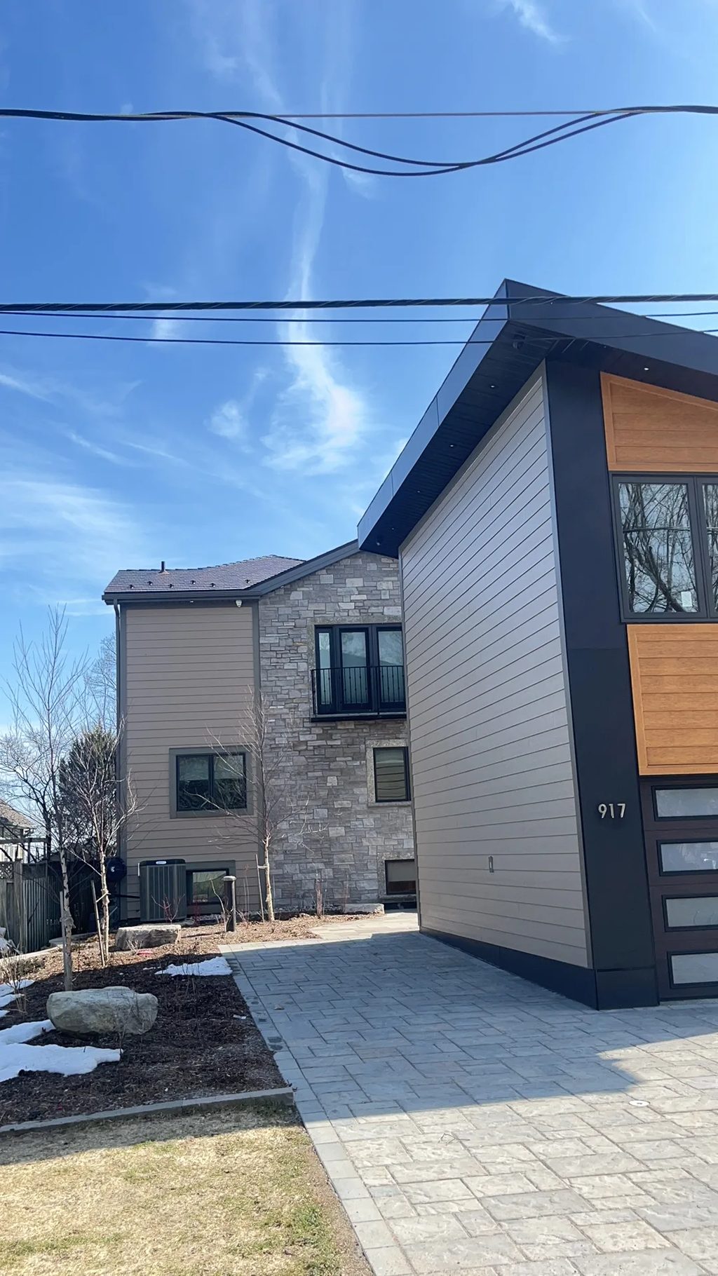 Tudor Brown Interlock Cedar Shingle aluminum roof on a Tudor Brown metal roof on a modern single-family home in, Innsifil, Ontario