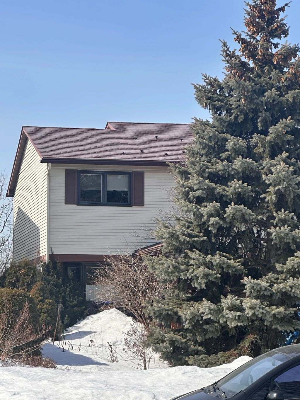 Aged Copper Interlock Shingle aluminum roof being installed on the home, replacing an asphalt shingle roof being torn off, Gloucester, Ontario