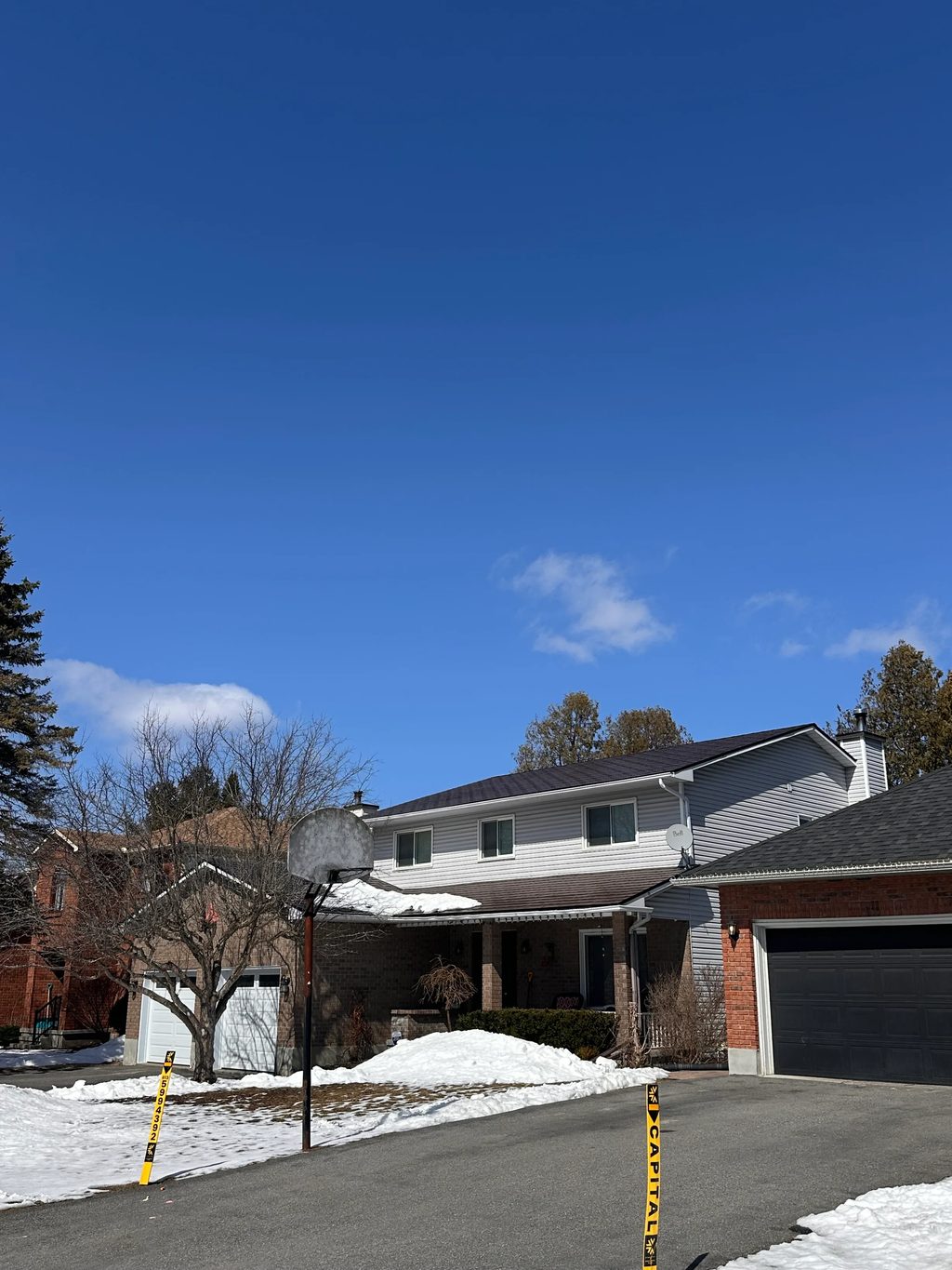 Colonial Brown Interlock Shingle aluminum roof on a Colonial brown metal roof on a two-storey suburban home, Stittsville, Ontario