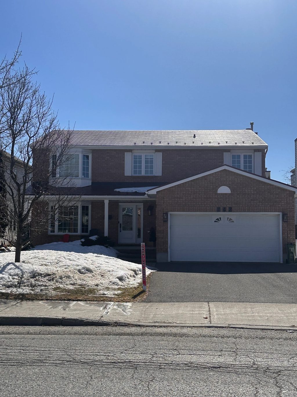 Tile Red Interlock Shingle aluminum roof on a red brick two-storey home with a metal roof in the suburbs, Orléans, Ontario
