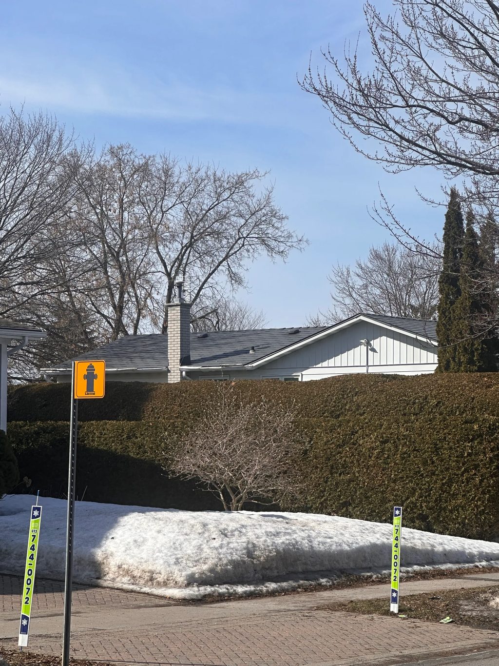 Charcoal Grey Interlock Shingle aluminum roof on a white single-family home with a metal roof in a suburban, Ottawa, Ontario