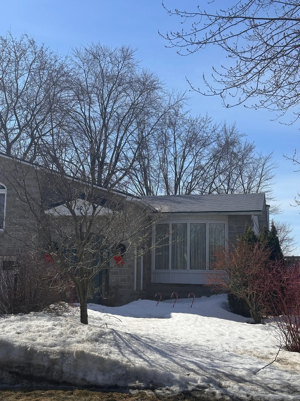 Charcoal Grey Interlock Shingle aluminum roof being installed on a grey single-family home with dormers in a forested rural, Gloucester, Ontario