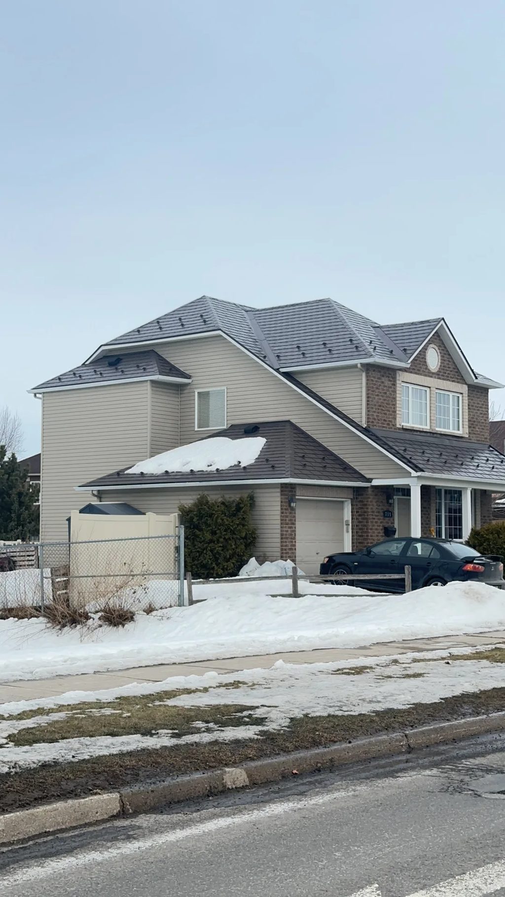 Tudor Brown Interlock Slate aluminum roof being installed on the home, replacing an asphalt shingle roof being torn off, Orléans, Ontario