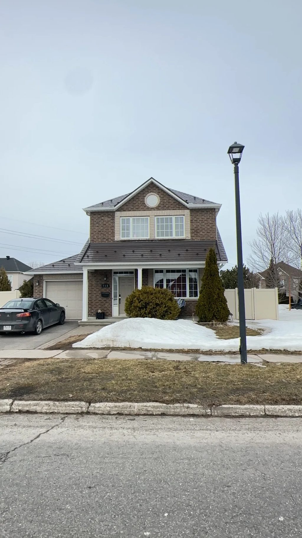 Tudor Brown Interlock Slate aluminum roof on a brown Tudor home with dormers in a snowy suburban, Orléans, Ontario