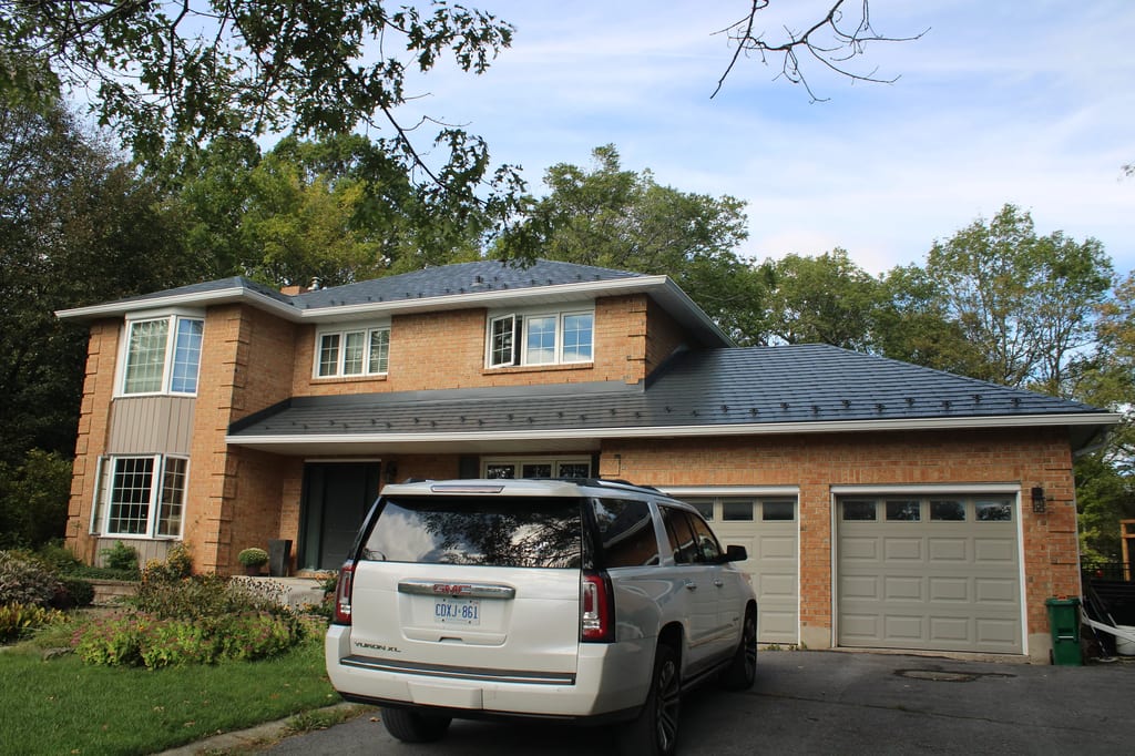Deep Charcoal Interlock Slate aluminum roof on a two-storey home with a Deep Charcoal metal roof in a, Kingston, Ontario