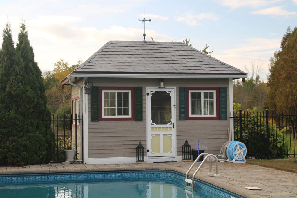 Deep Charcoal Interlock Slate aluminum roof on a tan house with a pool among tall trees, Carleton Place, Ontario