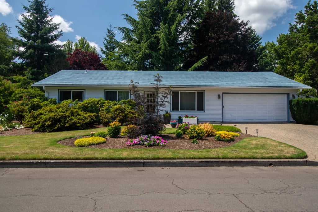 Charcoal Grey Interlock Shingle aluminum roof on a ranch-style home with a grey metal roof in a forested, Hillsboro, Oregon