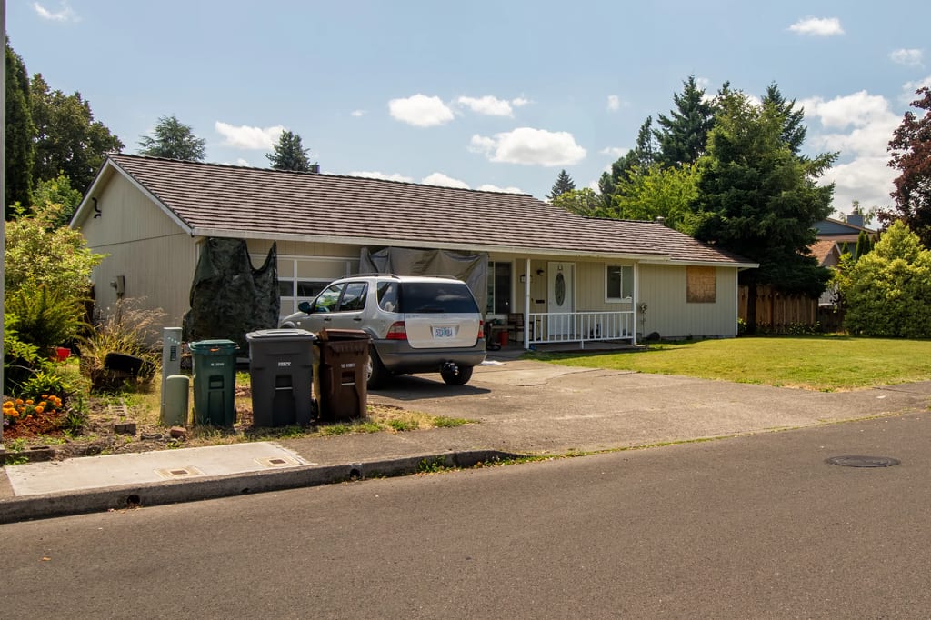 Colonial Brown Interlock Shake aluminum roof on a white one-storey home with a metal roof in a residential, Hillsboro, Oregon