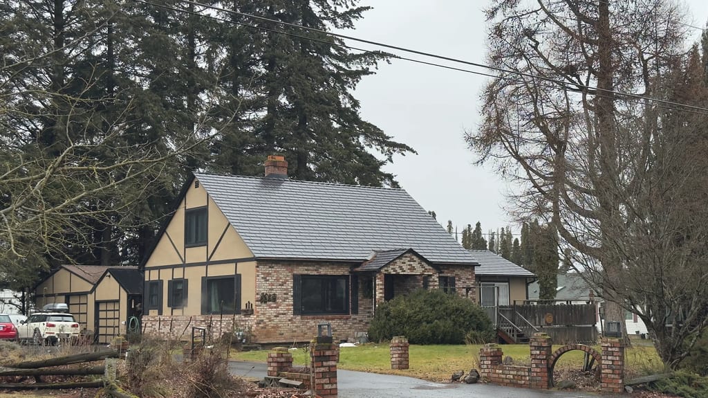 Black Interlock Cedar Shingle aluminum roof on a stone cottage with a metal roof in a rural mountain, Hood River, Oregon