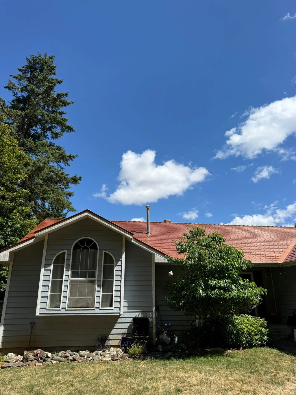 Copper Penny Interlock Slate aluminum roof on a grey single-family home with an orange metal roof in a, Corvallis, Oregon