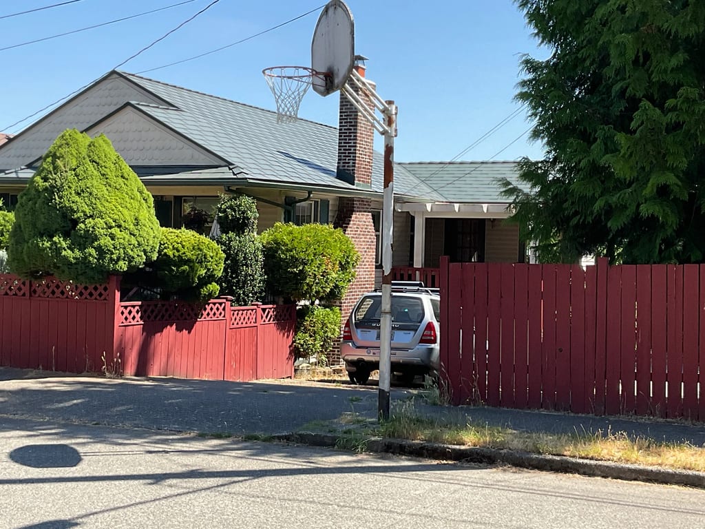 Hunter Green Interlock Shingle aluminum roof on a two-storey home with dormers in a Seattle neighbourhood, Seattle, Washington