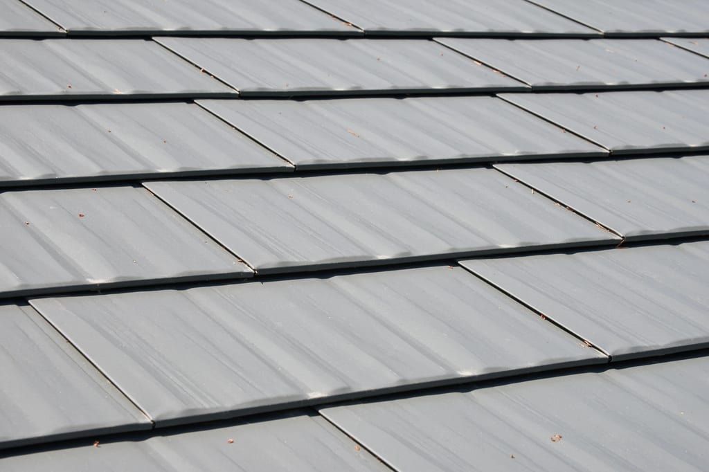 Musket Grey Interlock Cedar Shingle aluminum roof on a grey two-storey home with dormers and a metal roof in, Arlington, Washington