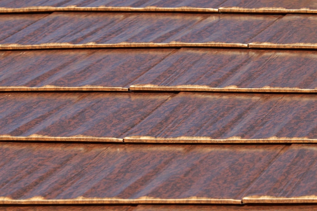 Aged Copper Interlock Cedar Shingle aluminum roof on a modern home with a metal roof in a lush green urban, Burien, Washington