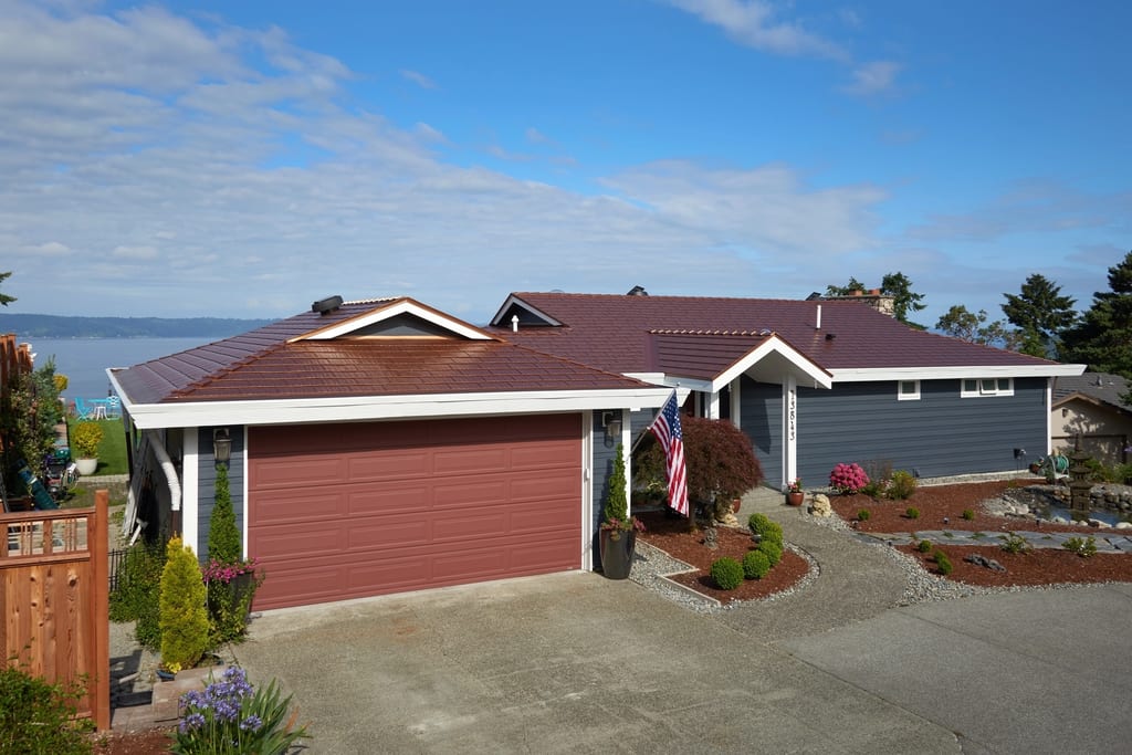 Aged Copper Interlock Cedar Shingle aluminum roof on a red ranch home with a metal roof overlooking a lake, Burien, Washington