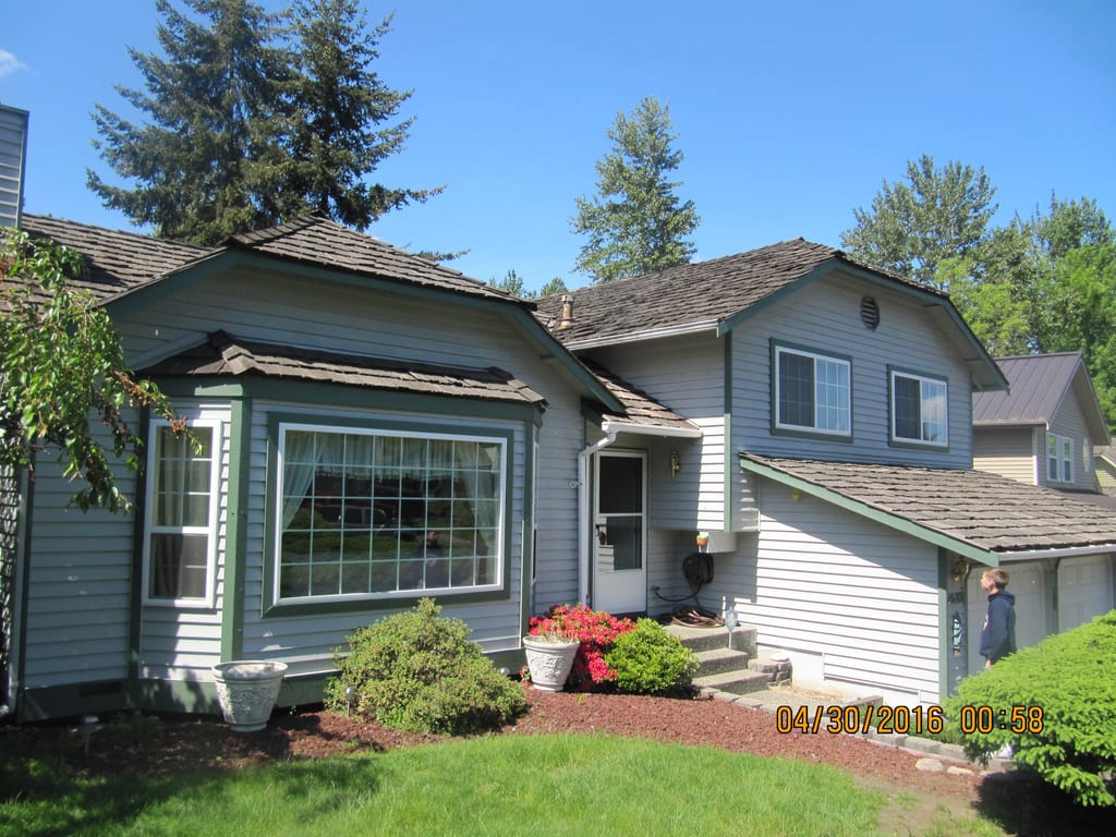 Before: a worn out wood shake roof on the home, Renton, Washington, ahead of a Colonial Brown Interlock Cedar Shingle aluminum roof