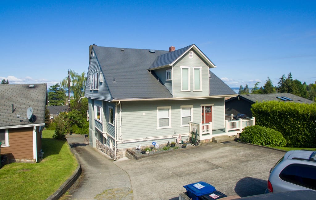 Musket Grey Interlock Slate aluminum roof on a light green two-storey home with dormers in a suburban, Seattle, Washington