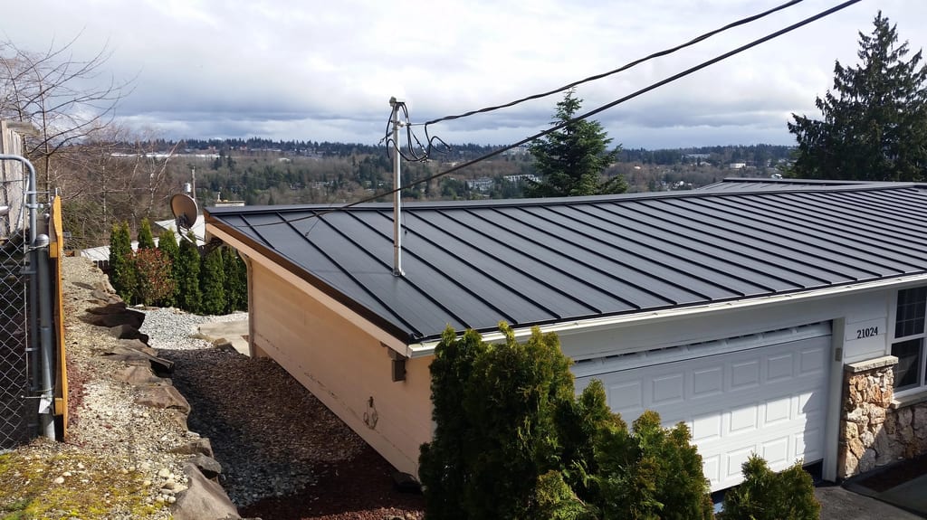 Black Interlock Standing Seam aluminum roof on a white modern home with a black metal roof and attached, Des Moines, Washington
