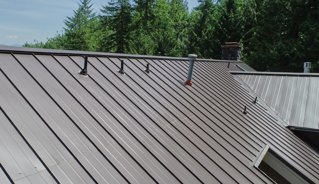 Tudor Brown Interlock Standing Seam aluminum roof on a brown single-storey Tudor home with dormers among tall, Fall City, Washington