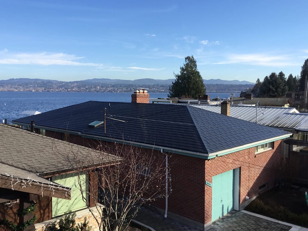 Black Interlock Slate aluminum roof on a brick house with a metal roof overlooking the ocean, Seattle, Washington
