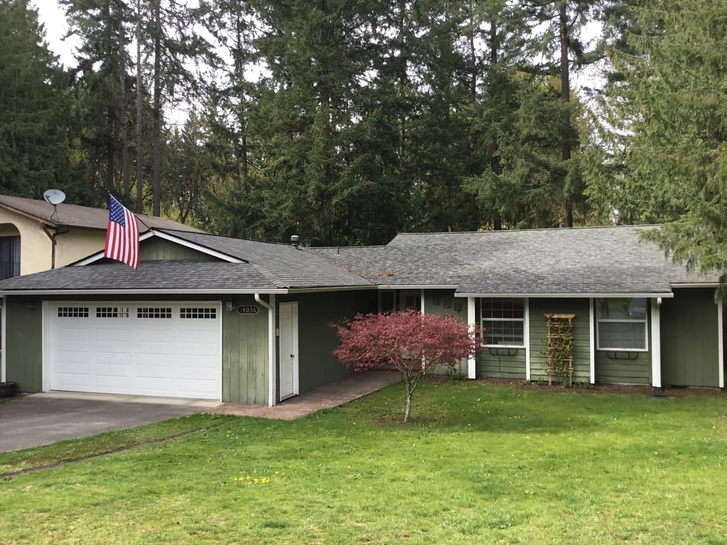 Before: a worn out asphalt shingle roof on the home, Renton, Washington, ahead of a Deep Charcoal Interlock Slate aluminum roof