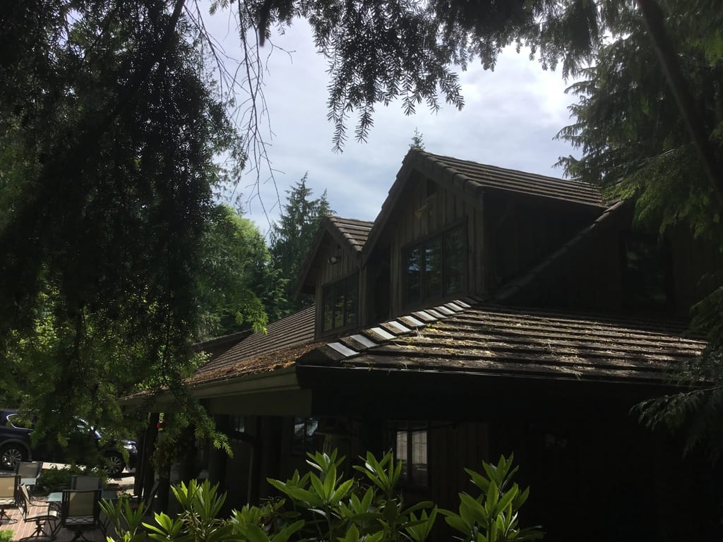 Before: a concrete tile roof with broken tiles on the home, Preston, Washington, ahead of a Hunter Green Interlock Standing Seam aluminum roof