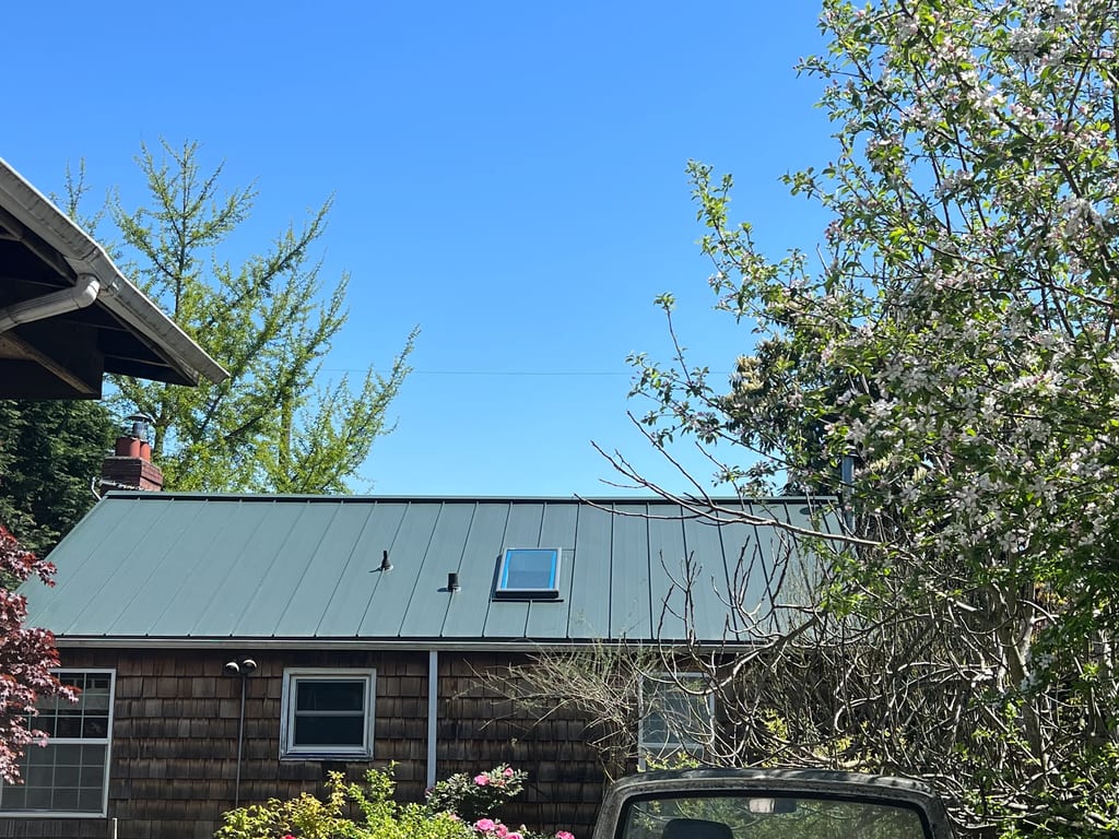 Hunter Green Interlock Standing Seam aluminum roof on a house with a green metal roof in a suburban neighbourhood, Seattle, Washington