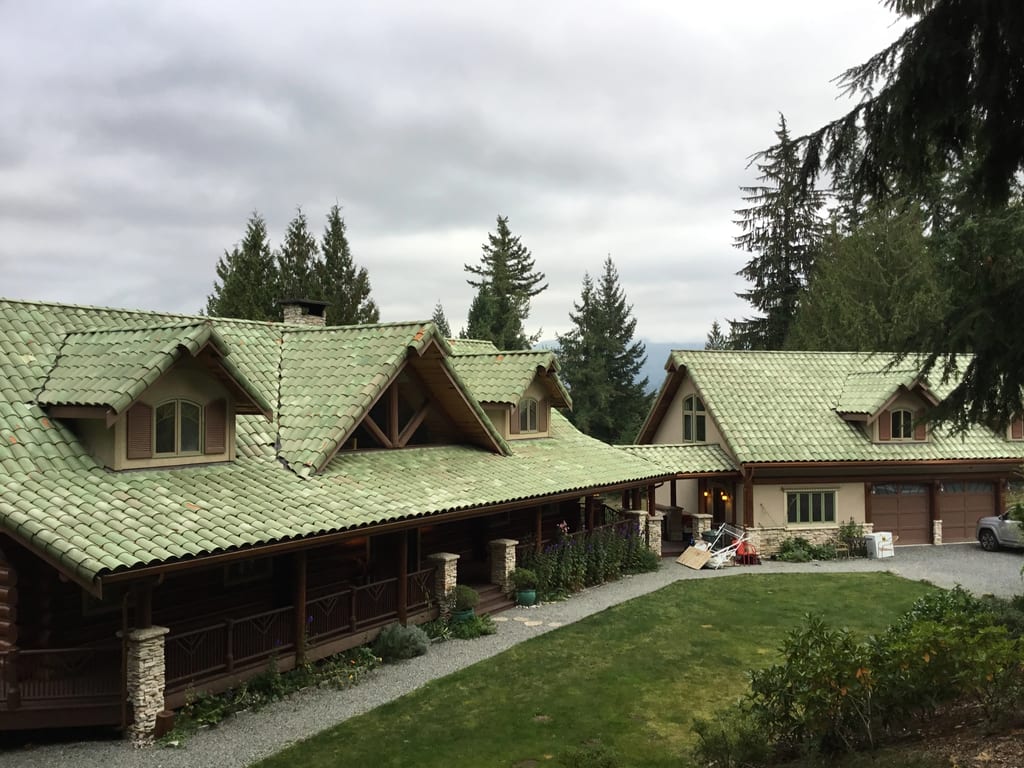 Before: a worn out clay tile roof on the home, Bellingham, Washington, ahead of a Copper Penny Interlock Shake aluminum roof
