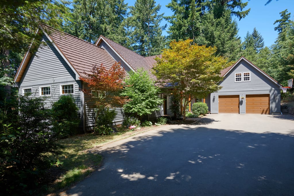 Colonial Brown Interlock Shake aluminum roof on a Colonial home in a forested area with a brown metal roof, Gig Harbor, Washington