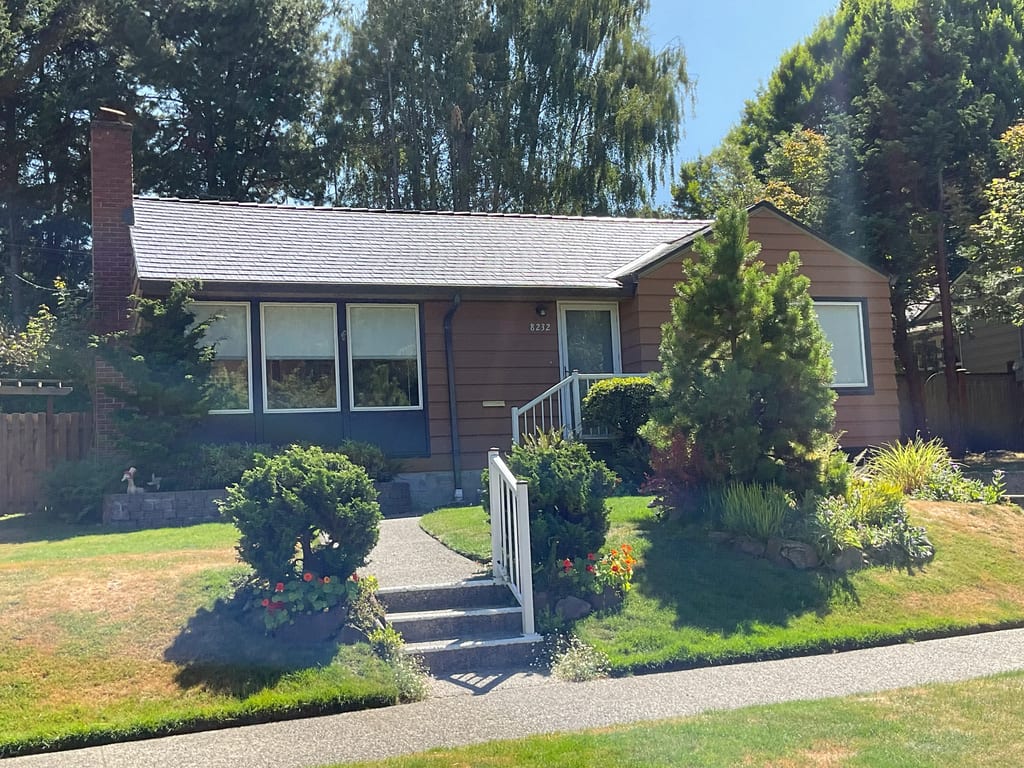 Deep Charcoal Interlock Cedar Shingle aluminum roof on a brown one-storey home with a metal roof in a suburban, Seattle, Washington