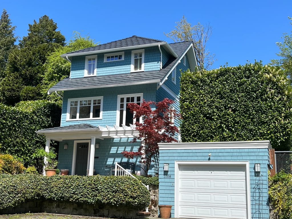 Deep Charcoal Interlock Shake aluminum roof on a Deep Charcoal Interlock Shake roof on a two-storey blue, Seattle, Washington