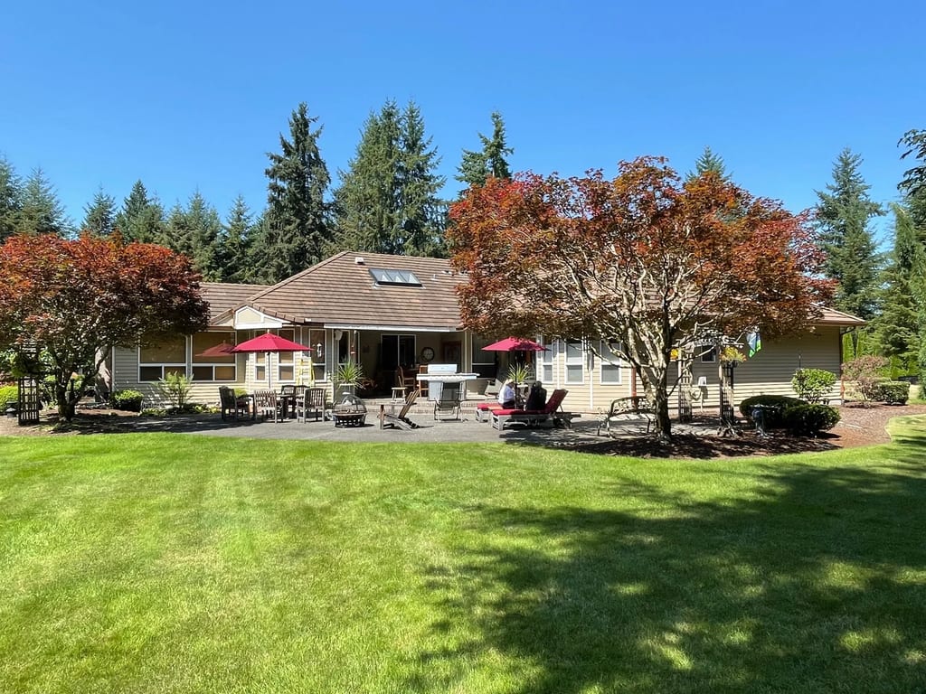Before: a concrete tile roof with broken tiles on the home, Auburn, Washington, ahead of a Copper Penny Interlock Shake aluminum roof