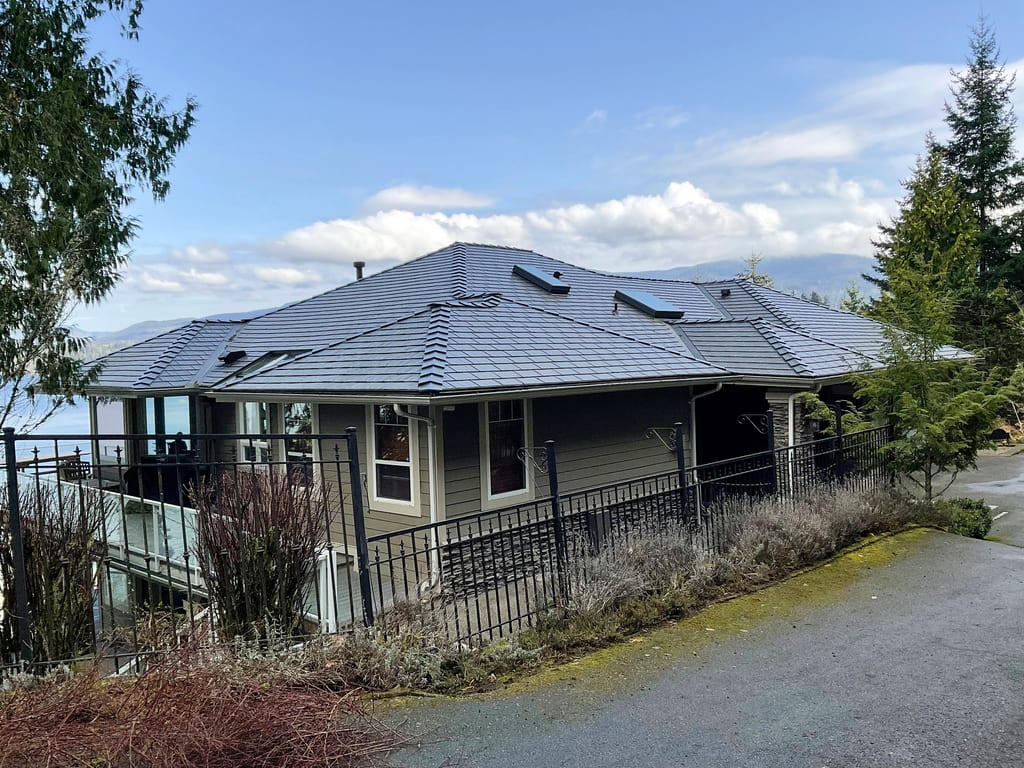 Deep Charcoal Interlock Cedar Shingle aluminum roof on a modern home with a metal roof in a forested mountain, Bellingham, Washington