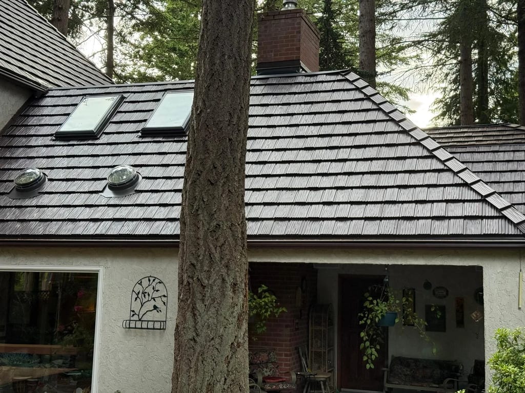 Colonial Brown Interlock Shake aluminum roof on a colonial brown metal roof on a white house among tall, Bellingham, Washington