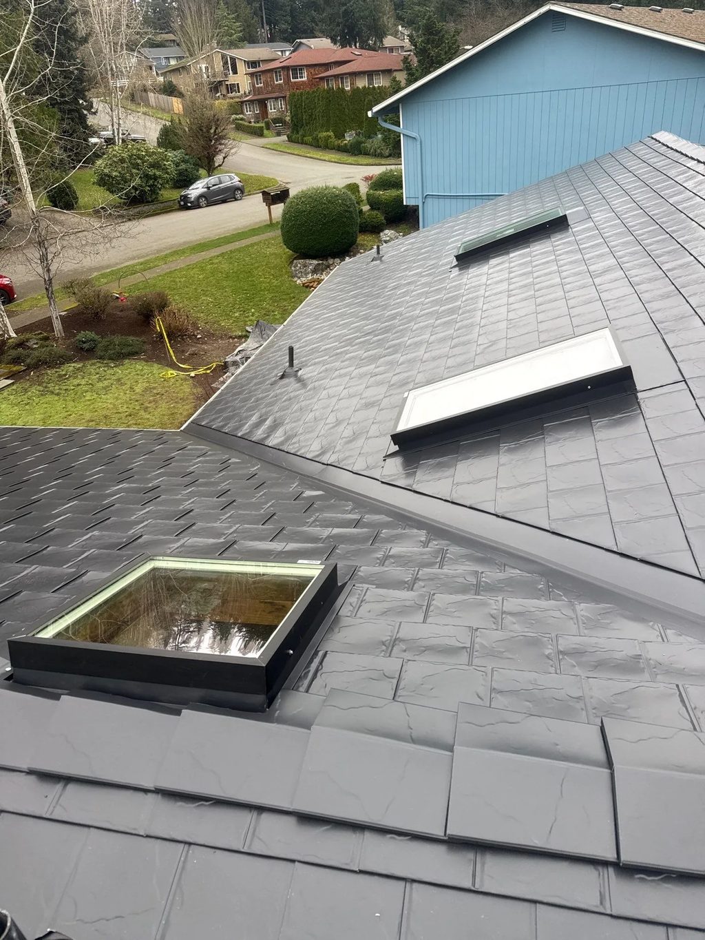 Black Interlock Slate aluminum roof on a single-family home with a black metal roof in a suburban, Redmond, Washington