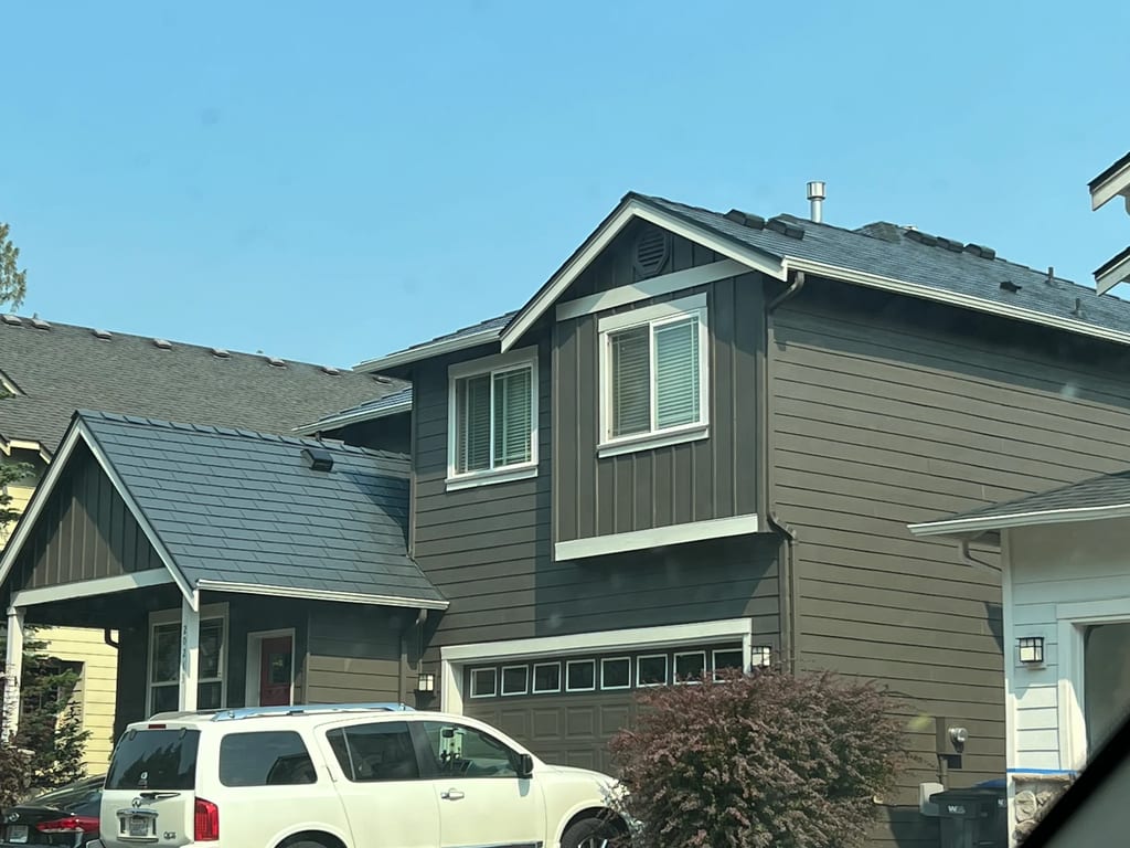 Deep Charcoal Interlock Slate aluminum roof on a two-storey home with dormers and a metal roof in, Lynnwood, Washington