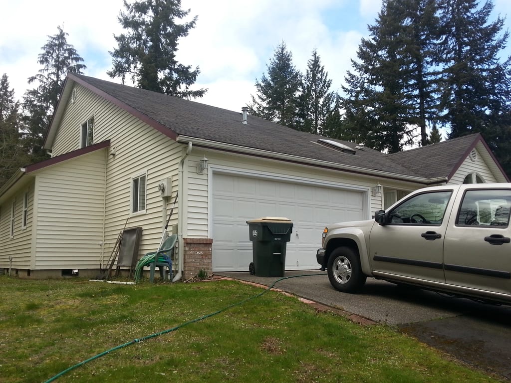 Before: a worn out asphalt shingle roof on the home, Olympia, Washington, ahead of a Tile Red Interlock Slate aluminum roof
