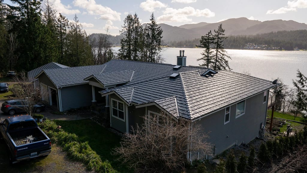 Deep Charcoal Interlock Shake aluminum roof on a grey ranch home on a waterfront property with a metal roof, Bellingham, Washington