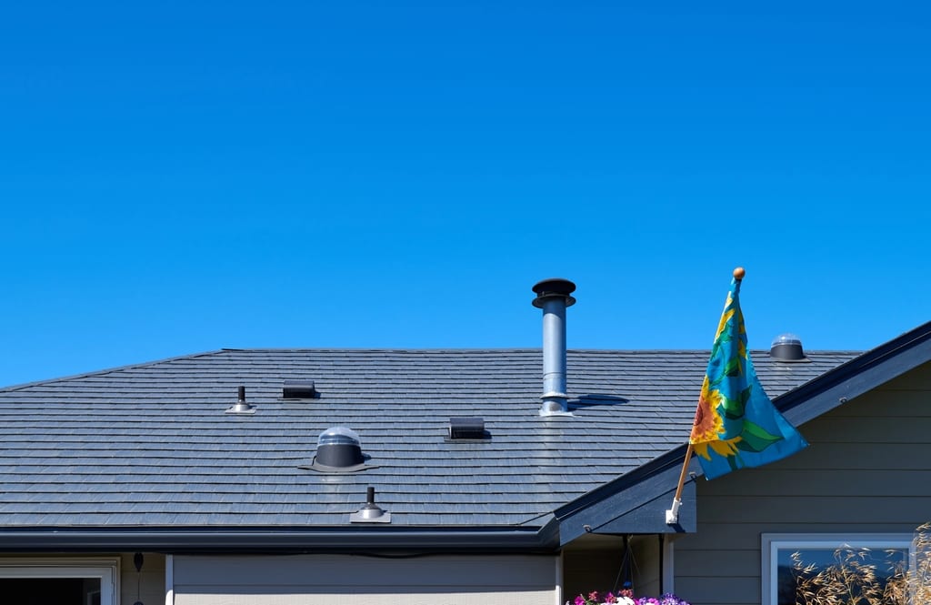 Deep Charcoal Interlock Slate aluminum roof on a single-family home with a metal roof in a rural setting, Sequim, Washington