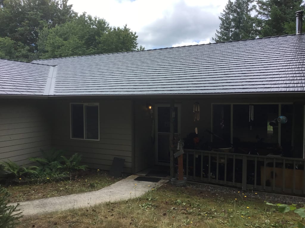 Deep Charcoal Interlock Cedar Shingle aluminum roof on a home with a brown exterior and a metal roof under, Tenino, Washington
