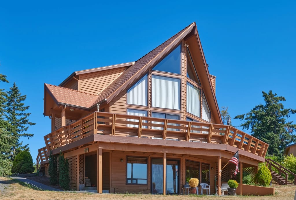 Copper Penny Interlock Cedar Shingle aluminum roof on a brown A-frame home with a metal roof near a forest, Sequim, Washington